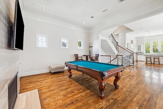 rec room with billiards, crown molding, and light wood-type flooring