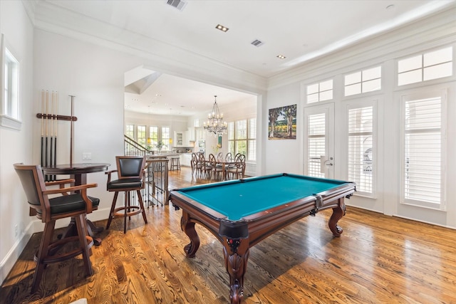 recreation room featuring crown molding, billiards, wood-type flooring, and an inviting chandelier