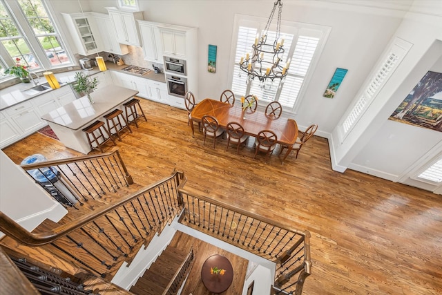 dining space featuring light wood-type flooring and a notable chandelier