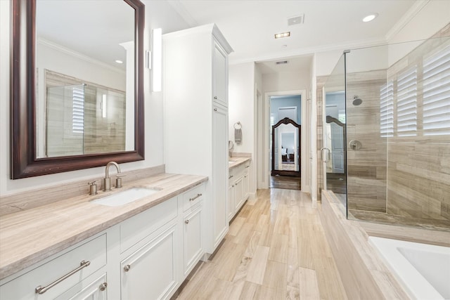 bathroom featuring walk in shower, crown molding, and vanity