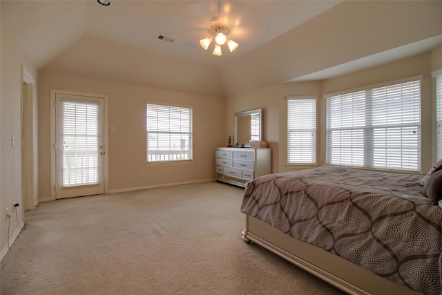 bedroom with a tray ceiling, light carpet, ceiling fan, and access to exterior