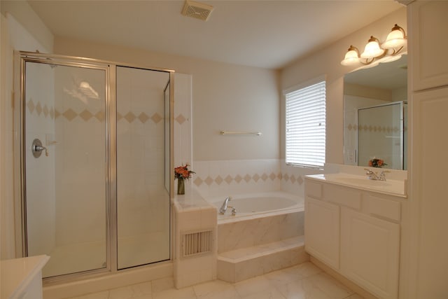 bathroom with shower with separate bathtub, vanity with extensive cabinet space, and tile flooring