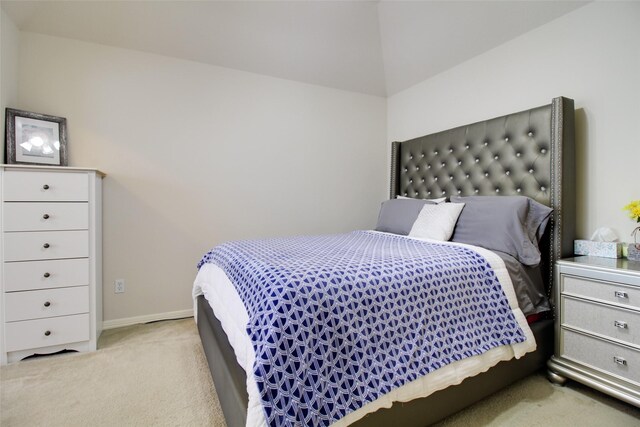 bedroom with carpet and lofted ceiling