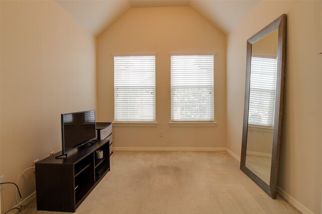 interior space featuring lofted ceiling and light colored carpet