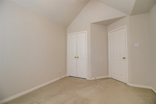 unfurnished bedroom with carpet and vaulted ceiling