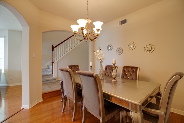 dining room featuring light hardwood / wood-style floors and a chandelier