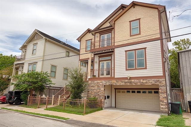 view of front of house featuring a garage and a balcony