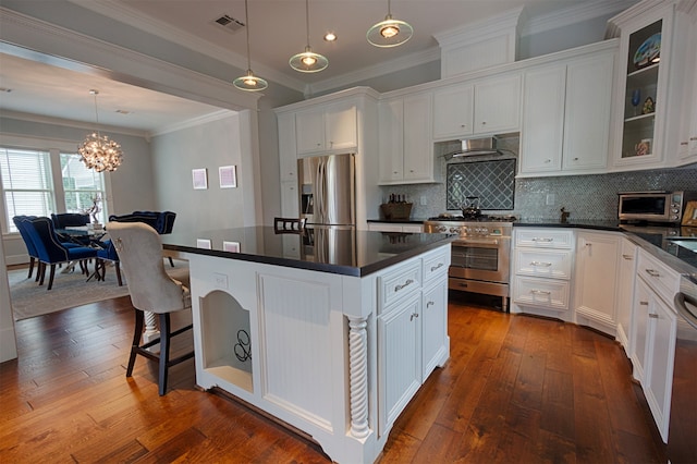 kitchen with a kitchen island, white cabinetry, and appliances with stainless steel finishes