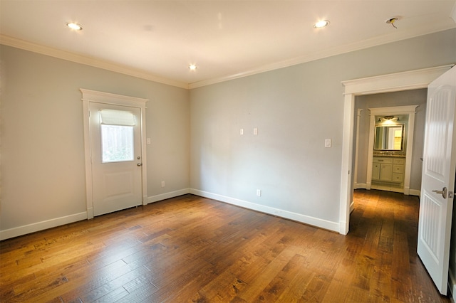 spare room featuring dark hardwood / wood-style flooring and ornamental molding