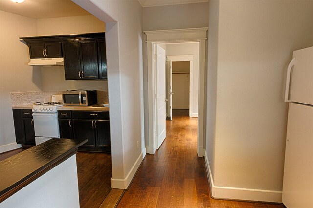 kitchen featuring dark hardwood / wood-style floors and white appliances