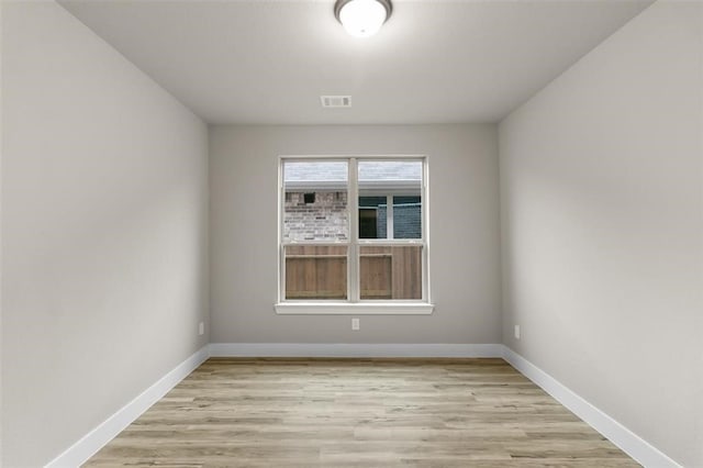 spare room with light hardwood / wood-style floors