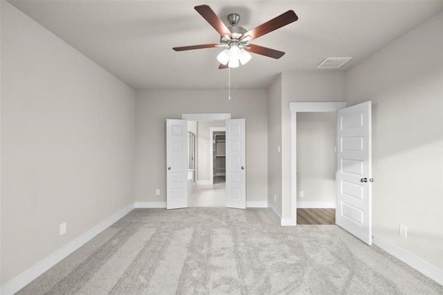 unfurnished bedroom featuring ceiling fan and light carpet