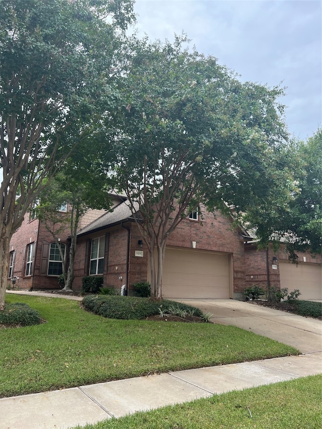 view of front of property with a garage and a front yard