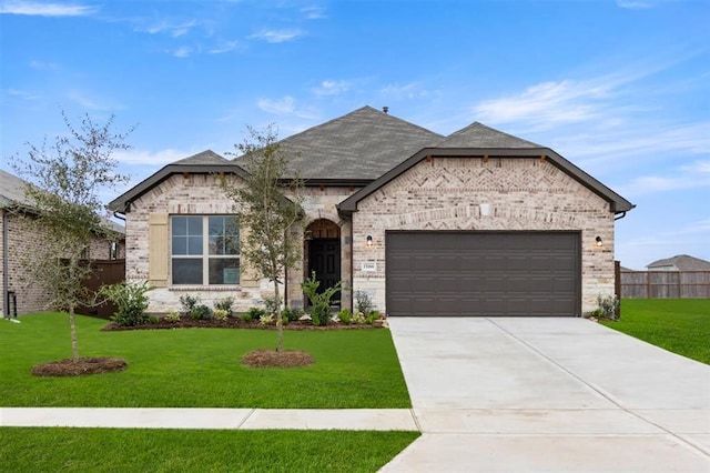 french country style house with a garage and a front yard