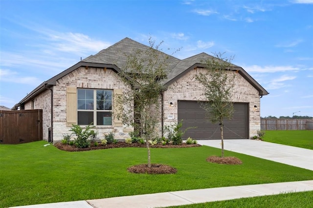 view of front of house with a garage and a front lawn