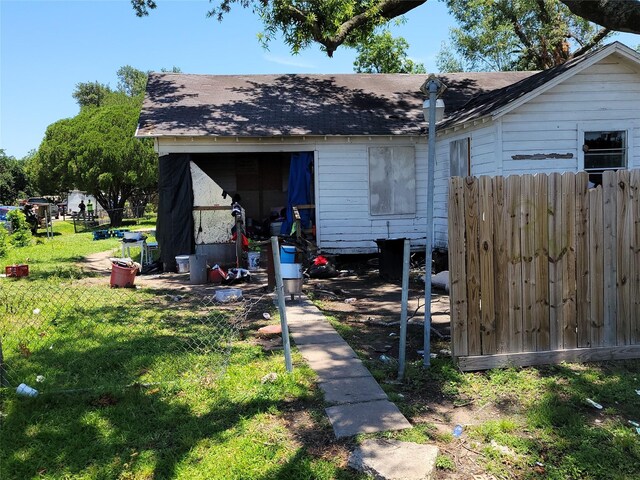 rear view of property featuring a lawn