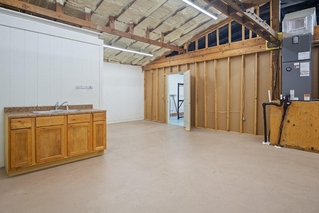 basement featuring heating unit and sink