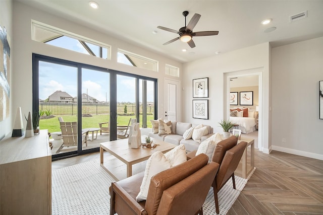 living room featuring ceiling fan and parquet floors