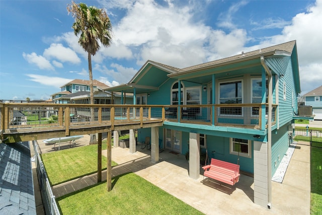 rear view of property with central AC unit, a yard, a patio, and a wooden deck