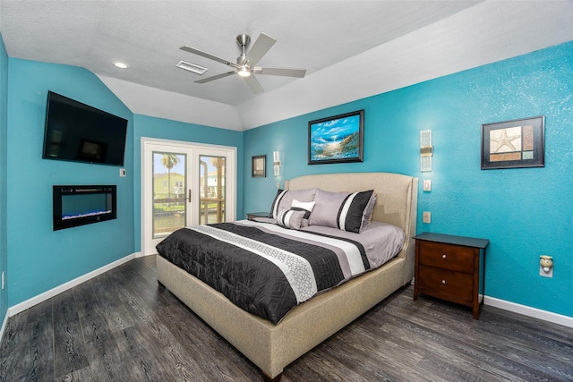 bedroom with lofted ceiling, dark hardwood / wood-style flooring, access to exterior, ceiling fan, and a textured ceiling