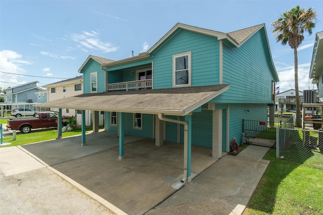 view of front facade featuring a carport and a balcony