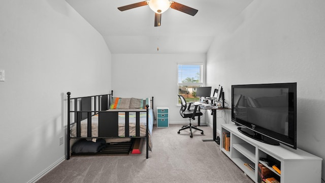 carpeted office space with vaulted ceiling and ceiling fan