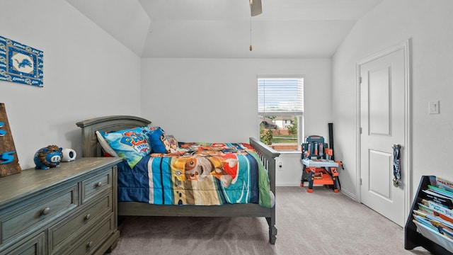 carpeted bedroom with a ceiling fan and lofted ceiling