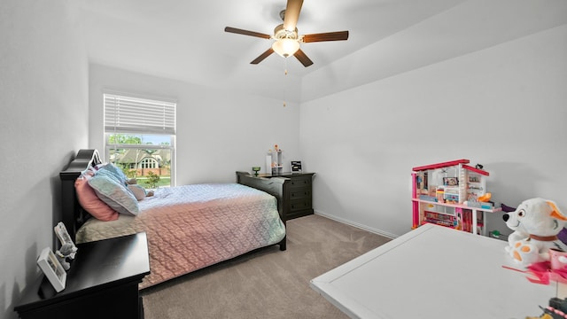 bedroom with light colored carpet, vaulted ceiling, and ceiling fan