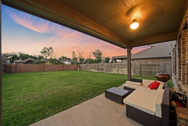 yard at dusk featuring a patio area