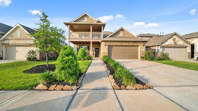 view of front of property with a balcony, a garage, and a front lawn