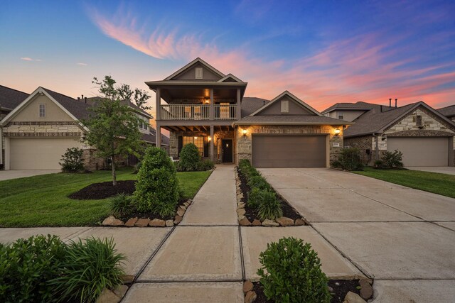 view of front of property with a lawn, a garage, and a balcony