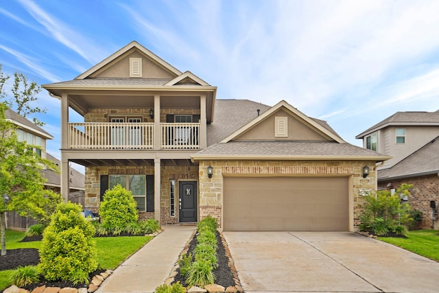 view of front facade featuring concrete driveway, a balcony, an attached garage, and stucco siding