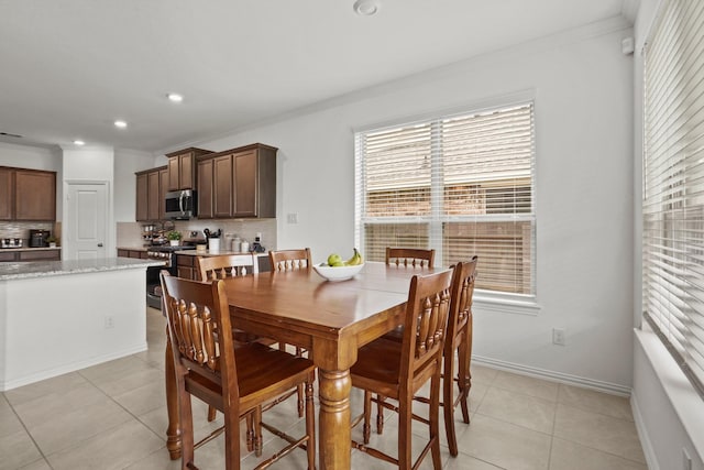 dining space featuring crown molding, light tile patterned floors, recessed lighting, visible vents, and baseboards