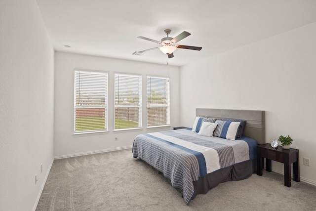 bedroom featuring ceiling fan and light carpet