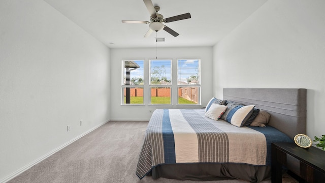 bedroom featuring a ceiling fan, carpet, visible vents, and baseboards