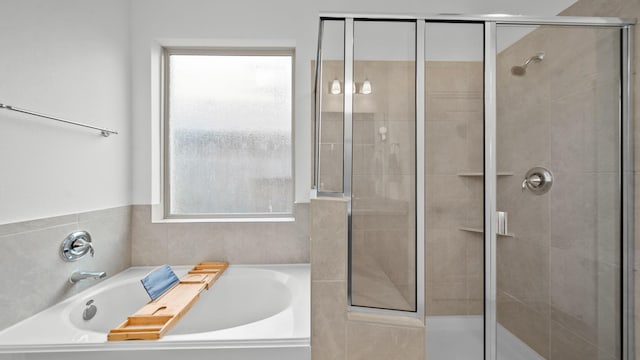 bathroom with separate shower and tub