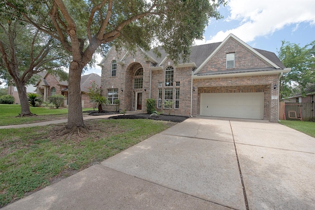 view of front facade featuring a garage and a front lawn