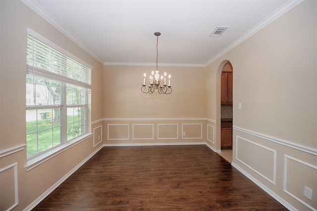 unfurnished dining area featuring dark hardwood / wood-style floors, crown molding, and a chandelier