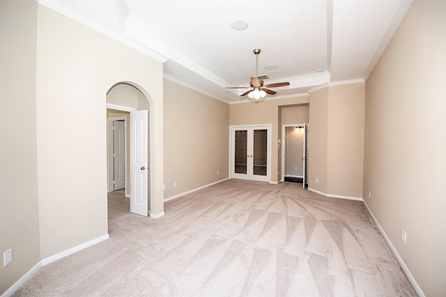 empty room featuring light carpet, ceiling fan, and ornamental molding