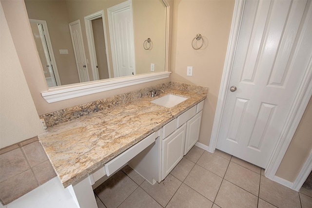 bathroom featuring tile patterned flooring and vanity