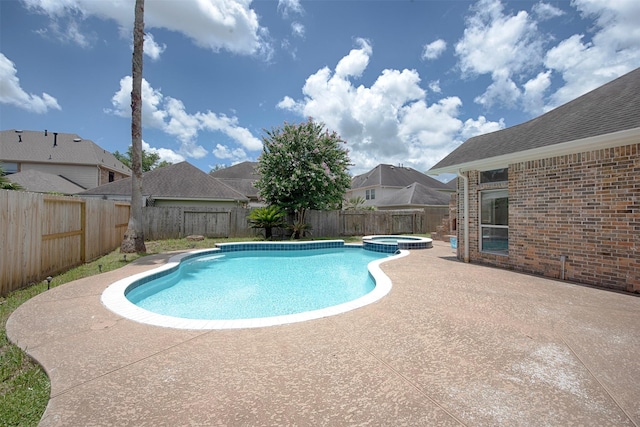 view of pool featuring a patio area and an in ground hot tub