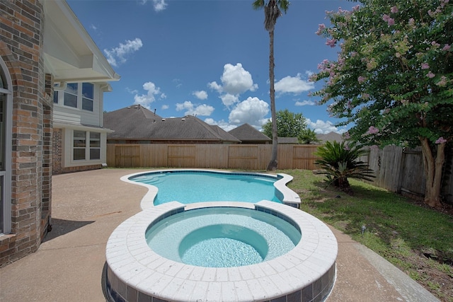 view of pool featuring a patio area and an in ground hot tub