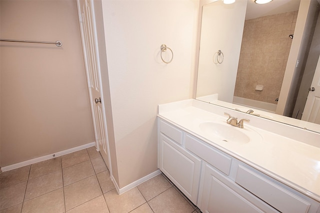 bathroom with tile patterned floors, vanity, and tiled shower / bath combo