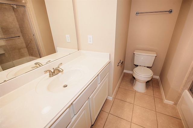 full bathroom with tile patterned floors, vanity, toilet, and bath / shower combo with glass door