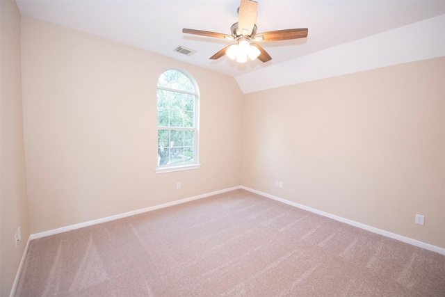 carpeted empty room featuring ceiling fan and lofted ceiling