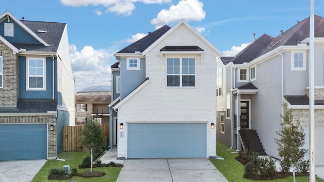 traditional home with a garage, brick siding, and concrete driveway