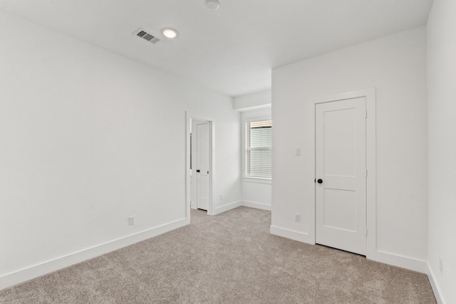 unfurnished bedroom with visible vents, baseboards, and carpet flooring