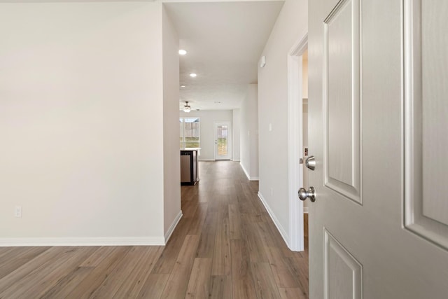 hallway with hardwood / wood-style flooring