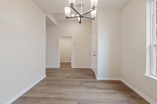 interior space featuring light hardwood / wood-style flooring and a chandelier