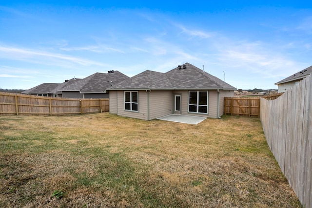 back of property featuring a patio area and a lawn